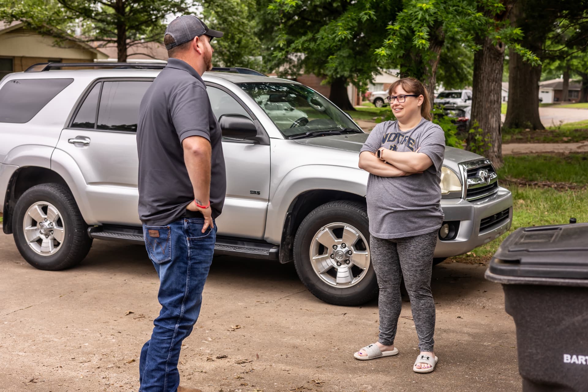 Nikki with an American Home Pros technician in her driveway